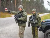  ?? Mindaugas Kulbis Associated Press ?? LITHUANIAN soldiers patrol near the Belarus border. Crossings have been closed amid rising tensions.