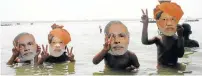  ?? Picture: IANS ?? GOING SWIMMINGLY: Children wearing Modi masks play in the Ganges River near the city of Varanasi, in northern India
