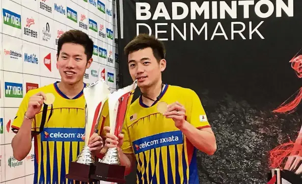  ??  ?? Goh V Shem (left) and Tan Wee Kiong showing off their medals and trophies after winning the men’s doubles title at the Denmark Open in Odense on Sunday.