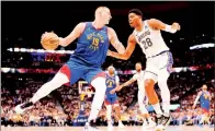  ?? PHOTO: ANDREW WEVERS-USA TODAY ?? The Denver Nuggets’ Nikola Jokic, left, drives to the basket against the Los Angeles Lakers’ Rui Hachimura during Game 1 of the first round of the NBA playoffs at the Ball Arena in Denver, Colorado, on Saturday.