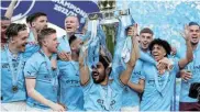  ?? Picture: LEE SMITH/REUTERS/ ?? WHEEL TURNS: Manchester City players celebrate after winning the Premier League in May last year. City have been charged with more than 100 alleged breaches of finance rules