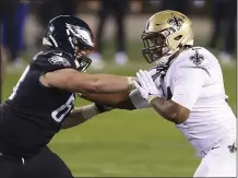  ?? RICH SCHULTZ - THE ASSOCIATED PRESS ?? Eagles tackle Jack Driscoll, left, tangles with the Saints’ Cameron Jordon on Sunday. Driscoll will reportedly miss the rest of the season with an MCL sprain.