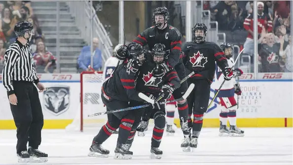  ?? CODIE MCLACHLAN ?? From left, Team Canada’s Bowen Byram, Xavier Parent, Alexis Lafreniere and Kirby Dach whoop it up after scoring a goal against Team USA in Hlinka Gretzky Cup semifinal action on Friday night. Canada won 6-5 in overtime and will face Sweden in Saturday’s final.