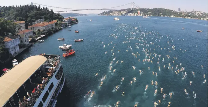  ??  ?? Swimmers race across the Bosporus in last year’s event.