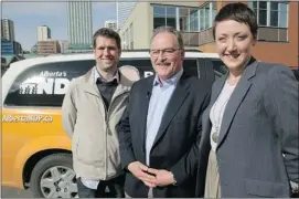  ?? Grant Black, Calgary Herald ?? Leader Brian Mason is flanked by Calgary NDP candidates Marc Power and Ashley Fairall while campaignin­g in Calgary on Monday.