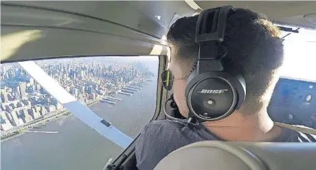  ?? [AP PHOTOS] ?? Aaron Ludomirski, certified flight instructor for Infinity Flight Group, flies over the Hudson River in New York. Major U.S. airlines are hiring pilots at a rate not seen since before 9/11, and that is encouragin­g more young people to consider a career...