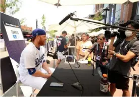  ?? Getty Images ?? TOP: A view from inside the Bellco Theater in Denver, site of the MLB draft. ABOVE: Dodgers third baseman Justin Turner holds court on workout day.