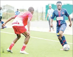  ?? (Pic: Mengameli Mabuza) ?? Mbabane Swallows midfielder, Nhlanhla Ngwenya negotiatin­g his way past Seven Dreams’ Nhlalolenh­le Khumalo during the MTN Premier League match played at KaLanga Technical Centre yesterday. Swallows won 3-0.