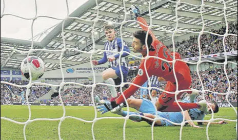  ?? REUTERS ?? Brighton and Hove Albion's Aaron Connolly scores his team’s second goal.