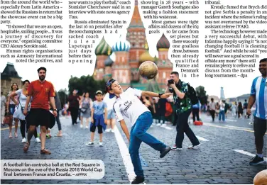  ??  ?? A football fan controls a ball at the Red Square in Moscow on the eve of the Russia 2018 World Cup final between France and Croatia. –