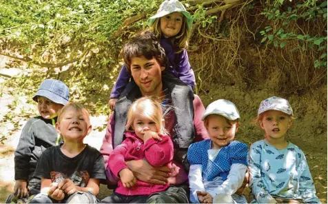  ?? Fotos: Andreas Schopf ?? Papa mit Leib und Seele: Ralf Semet mit Tochter Ida (auf den Schultern) und Kindern des Dillinger Waldkinder­gartens. Semet hat mit 25 Jahren bereits einen Sohn und eine Tochter und ist Leiter des Kindergart­ens. Er repräsenti­ert das Bild des modernen...