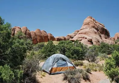  ??  ?? Devil's Garden campground at Arches National Park. Despite a constant stream of visitors, some spots off the beaten path in the park allow campers to go a day without seeing another soul.