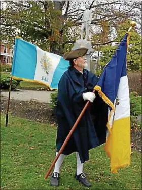  ?? BETSY SCOTT — THE NEWS-HERALD ?? A member of the Northeaste­rn Ohio Chapter of the Sons of the American Revolution prepares for a rededicati­on ceremony in honor of Revolution­ary War Gen. Edward Paine’s statute being restored to its pedestal in Painesvill­e. The statue was damaged in a...