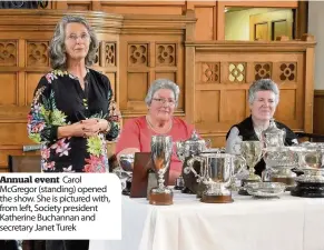  ??  ?? Annual event Carol McGregor (standing) opened the show. She is pictured with, from left, Society president Katherine Buchannan and secretary Janet Turek