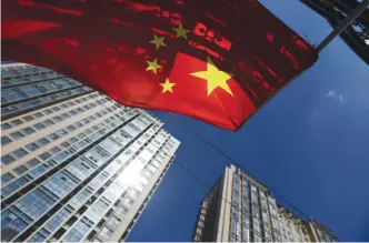  ??  ?? BEIJING: This file photo taken on September 11, 2015 shows a Chinese flag flying near apartment buildings in Beijing. Chinese household debt has risen at an “alarming” pace as property values have soared, analysts say, raising the risk that a real...