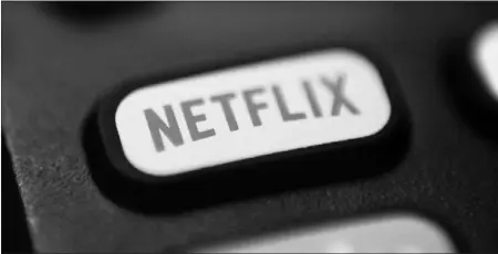  ?? JENNY KANE / AP FILE (2020) ?? A logo for Netflix is seen on a remote control. Netflix is testing a way to crack down on password sharing. The service has been asking some users to verify that they live with the holder of the account.