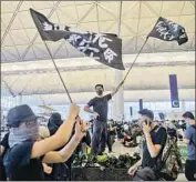  ?? Jerome Favre EPA/Shuttersto­ck ?? PROTESTERS occupying Hong Kong’s airport succeeded in bringing operations to a halt on Monday.