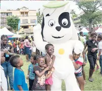  ??  ?? Left: Discovery Channel’s official mascot, Doki, joins in on the fun as he dances and entertains these students at the back-to-school fair.