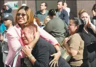  ?? Associated Press file photo ?? Two women hold each other as they watch the World Trade Center burn following a terrorist attack on the twin towers in New York on Sept. 11, 2001.