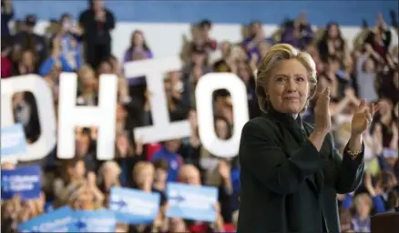  ?? ANDREW HARNIK, THE ASSOCIATED PRESS ?? Democratic presidenti­al candidate Hillary Clinton claps after speaking at a rally at Cuyahoga Community College in Cleveland, Friday.