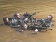  ?? THE ASSOCIATED PRESS ?? Soldiers from the U.S. Army’s 25th Infantry Division cross a stream as part of their jungle warfare training at Schofield Barracks in Hawaii.