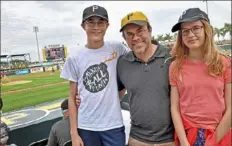  ?? Matt Freed/Post-Gazette ?? Cranberry native Justin Loy took his children, Jonah, 14, and Anna, 11, to see the Pirates’ spring training Wednesday at LECOM Park in Bradenton, Fla.