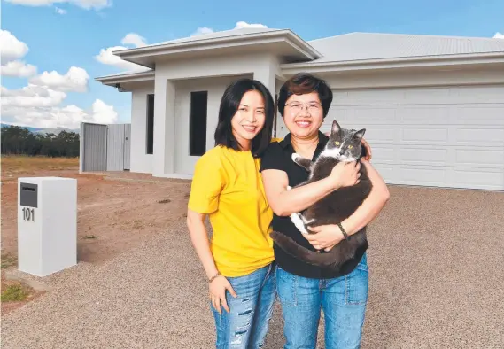  ?? ?? Thi Tran and Christy Truong, with their cat Fletcher, have relocated from Melbourne and have built a home in Townsville. Picture: Evan Morgan