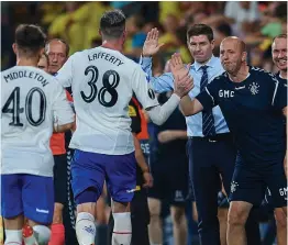  ??  ?? Gary McAllister congratula­tes Kyle Lafferty on his goal at Villarreal