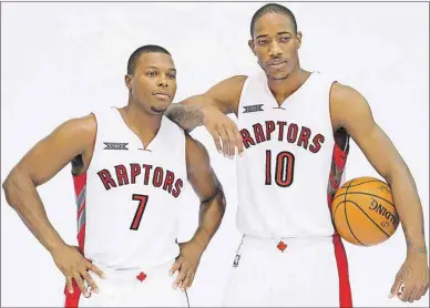  ?? CANADIAN PRESS PHOTO ?? Toronto Raptors’ Kyle Lowry, left, and DeMar DeRozan pose for photos during the team’s media day at the Air Canada Centre in Toronto on Monday, Sept. 29.