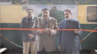  ?? -APP ?? Federal Minister for Railways Sheikh Rashid Ahmed cutting the ribbon to restore the Kohat Express and Subak Kharam railcars suspended due to COVID-19.