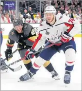  ?? BRUCE BENNETT/GETTY-AFP ?? The Capitals’ John Carlson, right, skates ahead of the Golden Knights’ Jonathan Marchessau­lt during Game 2.