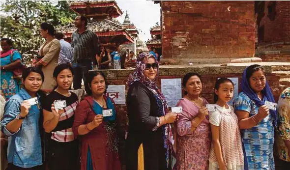  ?? EPA PIC ?? Nepalese waiting to cast their votes at a polling station in Kathmandu yesterday.