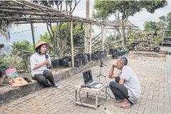  ??  ?? Teacher Vincentia Orisa Ratih Prastiwi records a video for her students to watch online, in Kenalan, Indonesia.