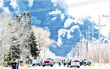  ??  ?? Dark smoke rises from Husky Energy oil refinery following an explosion in Superior, Wisconsin. — Reuters photo