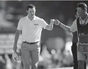  ?? NICK WASS AP ?? Patrick Cantlay fist bumps his caddie after his birdie putt on the 18th hole gave him a one-shot lead at 12-under.