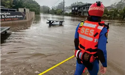  ?? ?? SES workers survey flood waters at Lake Conjola on the NSW south coast on Wednesday. Photograph: NSW SES Facebook page