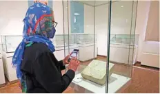  ?? ?? A visitor attends an exhibition entitled the Repatriate­d Boukan Glazed Brick Collection from Switzerlan­d, at Iran’s National Museum in Tehran. — AFP photos