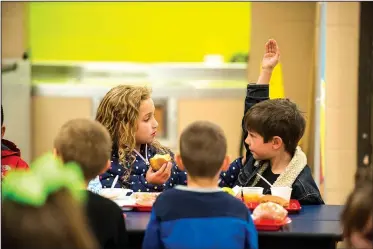  ?? NWA Democrat-Gazette/SPENCER TIREY ?? Aubrey Scallan (left) and Harrison Placzek talk Tuesday during lunch at Sugar Creek Elementary School in Bentonvill­e. Janet Schwanhaus­ser, the Bentonvill­e district’s finance director, developed the “Every Kid, Every Day” campaign to offset the cost of...