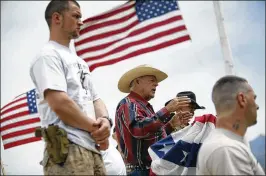  ?? JOHN LOCHER / LAS VEGAS REVIEW-JOURNAL 2014 ?? Flanked by armed supporters, rancher Cliven Bundy speaks at a protest camp near Bunkervill­e, Nev., in 2014. A judge is expected to announce a decision today on the case against Bundy stemming from the incident.