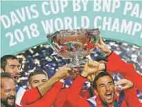  ?? THIBAULT CAMUS/ASSOCIATED PRESS ?? Croatia’s team captain Zeljko Krajan, left, and players lift up the cup after the team won the Davis Cup final between France and Croatia on Sunday in Lille, France. Croatia claimed a second title in the team event following its maiden win in 2005.