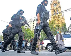  ??  ?? Police commandos patrol near the Pakistan Stock Exchange building in Karachi on Monday.