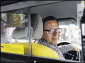  ?? Richard Drew The Associated Press ?? Taxi driver and taxi medallion owner Marcelino Hervias, in his cab on New York’s Upper West Side.