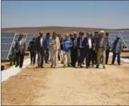  ?? ELENA BOFFETTA — AP PHOTO ?? Officials from the IKEA Foundation, and the U.N. refugee agency tour a newly inaugurate­d solar energy plant, that will provide about 20,000Syrian refugees with electricit­y, in the Azraq Refugee Camp, Jordan, Wednesday, April 17, 2017. The foundation...