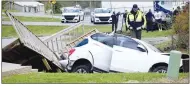  ?? Mike Eckels Westside Eagle Observer ?? A white SUV came to rest in a ditch near Third Ave. in Decatur April 14 after failing to negotiate the curve on Arkansas Highway 59 near Hill Avenue (upper left). After leaving the highway, the vehicle sideswiped a sign before smashing into a bridge and into a culvert near the Decatur United Methodist Church building.