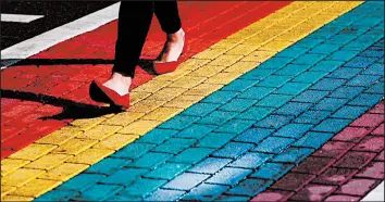  ?? JOSE M. OSORIO/CHICAGO TRIBUNE ?? A crosswalk on North Halsted Street was painted to represent LGBT pride in 2019 .