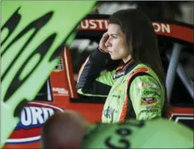  ?? CHERYL SENTER — THE ASSOCIATED PRESS FILE ?? In this file photo, Danica Patrick adjusts her earplug while waiting in the garage while her car is worked on during practice for the NASCAR Cup Series auto race at New Hampshire Motor Speedway in Loudon, N.H. Patrick is finishing her racing career...
