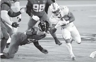  ??  ?? Dolphins running back Myles Gaskin runs past Jaguars defensive end K’Lavon Chaisson on Thursday. Gaskin has outperform­ed two veteran backs acquired in the offseason.