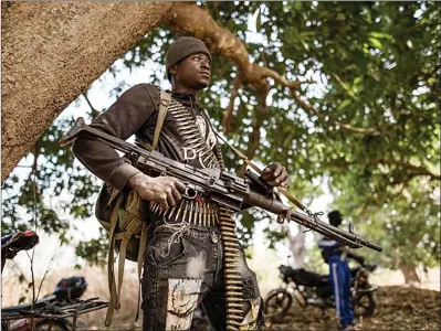  ?? Photo: EWN ?? Guard… A separatist belonging to the Movement of Democratic Forces of Casamance stands guard ahead of the release of seven captured Senegalese soldiers at an abandoned settlement in Gambia on 14 February 2022.