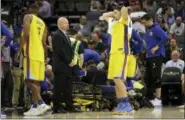  ?? RICH PEDRONCELL­I — THE ASSOCIATED PRESS ?? Golden State Warriors guard Klay Thompson, center right, reacts as teammate Patrick McCaw is tended to after falling hard to the floor late in the third quarter following a Flagrant-1 foul by Sacramento Kings’ Vince Carter in an NBA basketball game...