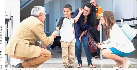  ??  ?? Reunited: Jelsin Aguilar Padilla shaking immigratio­n attorney Jorge L. Baron’s hand after stepping off his flight from New York as he is reunited with his mother Yolany in Seattle two months after they were separated. — AP